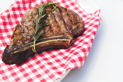 flame-broiled-steak seasoned & tenderized with Kalmes Famous 